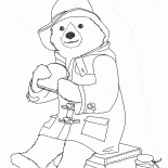 Paddington eating a sandwich