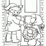 Children hang a wreath